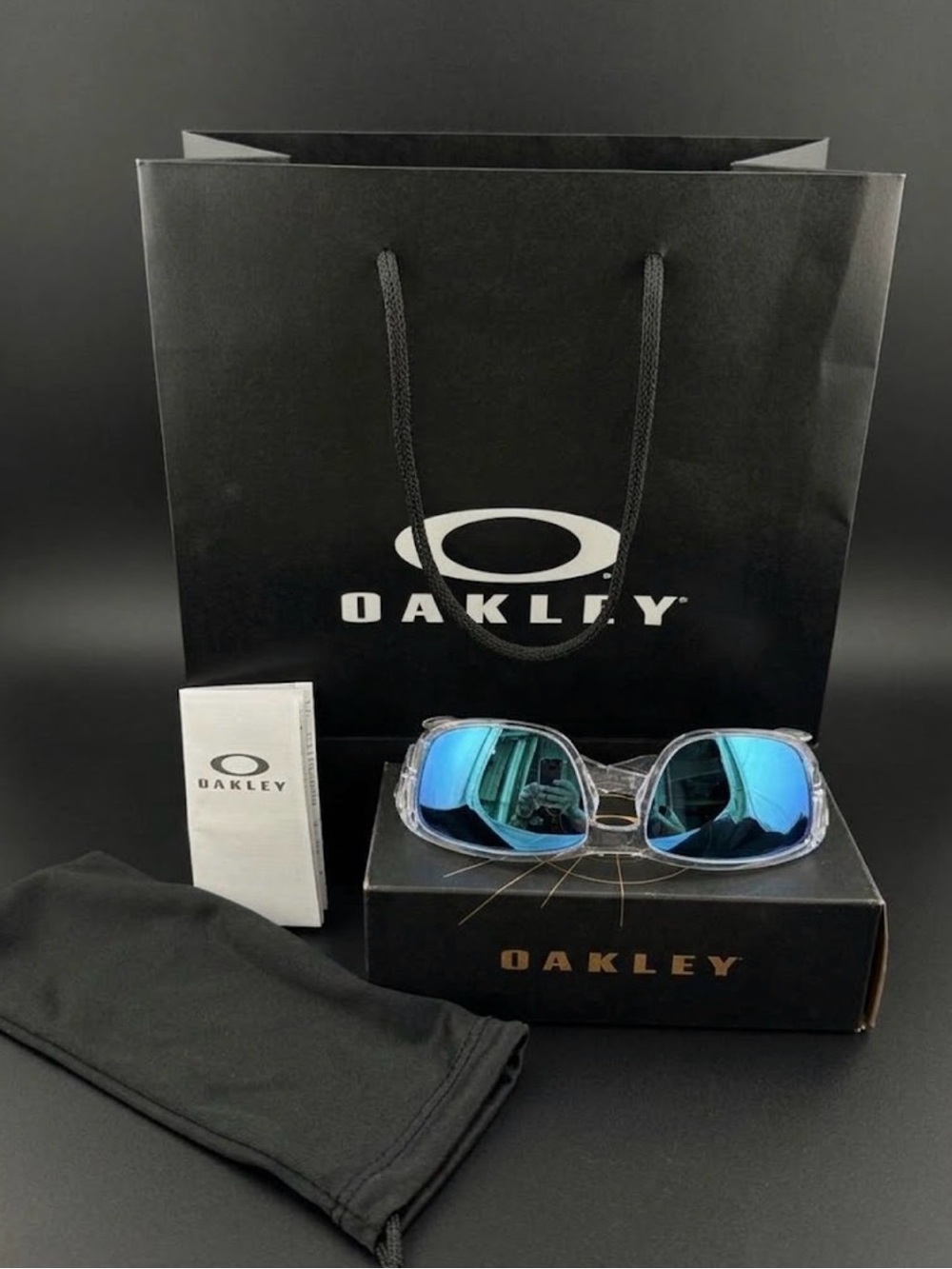 Oakley Men’s Clear Frame Sunglasses with Blue Mirrored Lenses Tourniquet